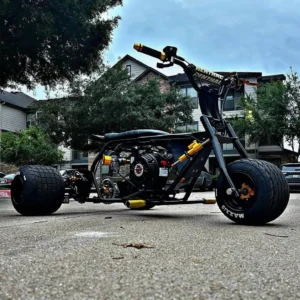 Black Handle Retriever drift trike front three-quarter view with black frame and gold accents