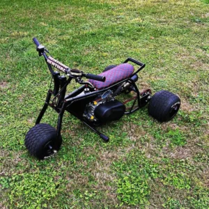 Black Spider drift trike with red diamond-stitched seat and blacked-out frame