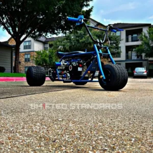 Blue Ranger electric blue drift trike side view on neighborhood street