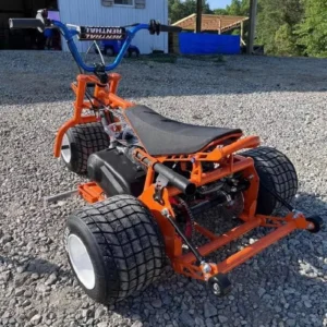 Hassle Pumpkin drift trike in bright orange with Renthal handlebars and wide rear tires
