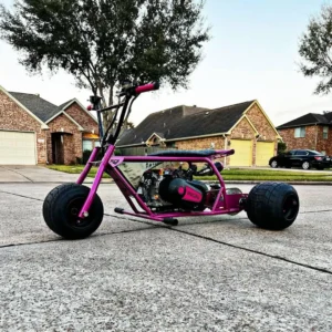 Pink Pearl hot pink drift trike rear three-quarter view on neighborhood street